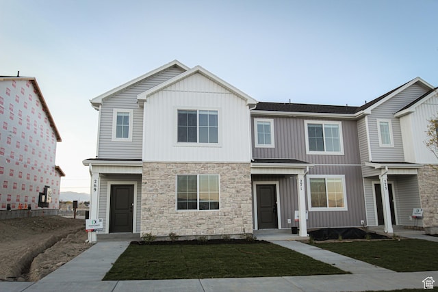 229 W 690 N, Smithfield, UT 84335 - view of front facade with stone siding, a front lawn, and board and batten siding