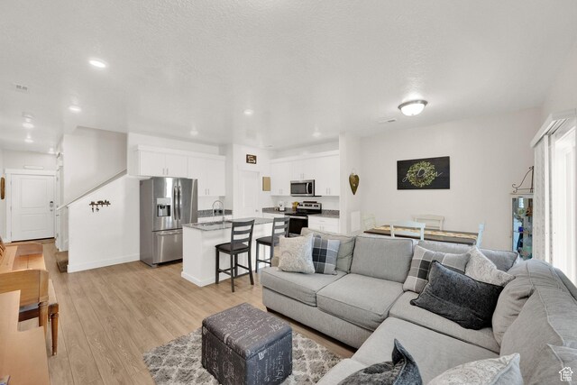 382 E 1850 N Unit 5, North Ogden, UT 84414 - living room featuring light wood-type flooring and recessed lighting