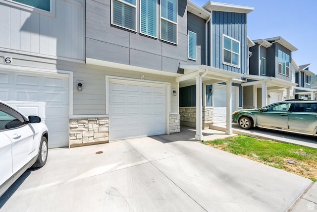382 E 1850 N Unit 5, North Ogden, UT 84414 - view of home's exterior featuring stone siding, driveway, and an attached garage