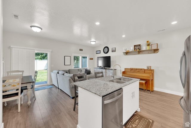 382 E 1850 N Unit 5, North Ogden, UT 84414 - kitchen with stainless steel appliances, light wood-style flooring, an island with sink, white cabinets, and recessed lighting