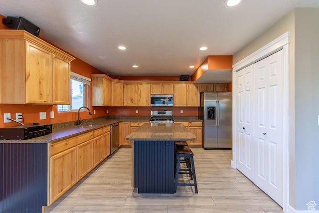 1033 S Southgate Ct W, Logan, UT 84321 - kitchen featuring stainless steel appliances, recessed lighting, a kitchen bar, a center island, and light wood finished floors