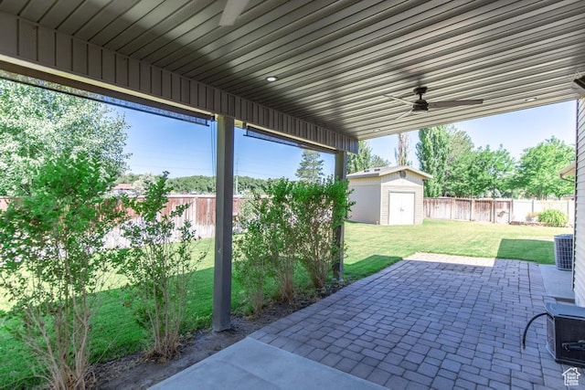 1033 S Southgate Ct W, Logan, UT 84321 - fenced backyard featuring a patio, a ceiling fan, and a storage unit