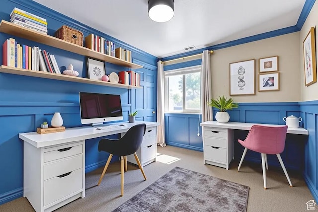 1033 S Southgate Ct W, Logan, UT 84321 - home office featuring built in desk, a decorative wall, light colored carpet, ornamental molding, and wainscoting