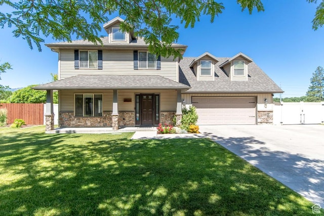 1033 S Southgate Ct W, Logan, UT 84321 - view of front of home with stone siding, concrete driveway, a garage, a gate, and a porch
