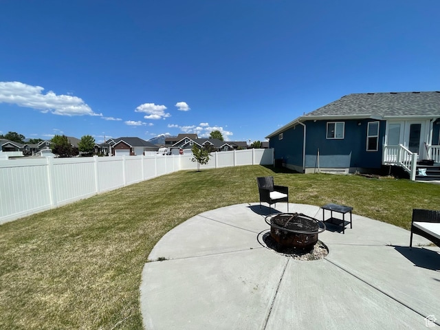 2433 N 1445 W, Clinton, UT 84015 - fenced backyard featuring a fire pit, a patio, and a residential view