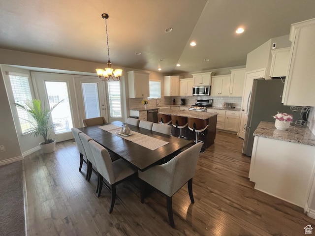 2433 N 1445 W, Clinton, UT 84015 - dining room featuring a chandelier, dark wood finished floors, recessed lighting, and vaulted ceiling