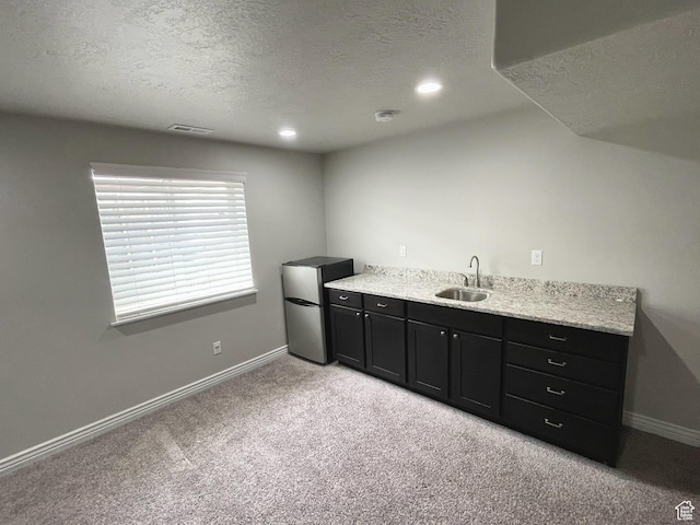 2433 N 1445 W, Clinton, UT 84015 - bar area with freestanding refrigerator, a textured ceiling, light colored carpet, and recessed lighting