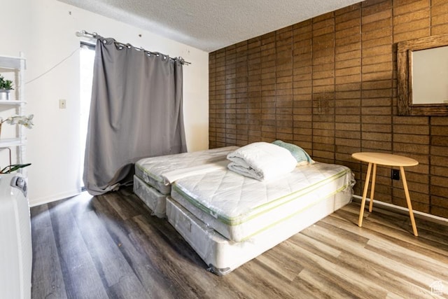 245 N Vine St Unit 205, Salt Lake City, UT 84103 - bedroom featuring wood finished floors and a textured ceiling