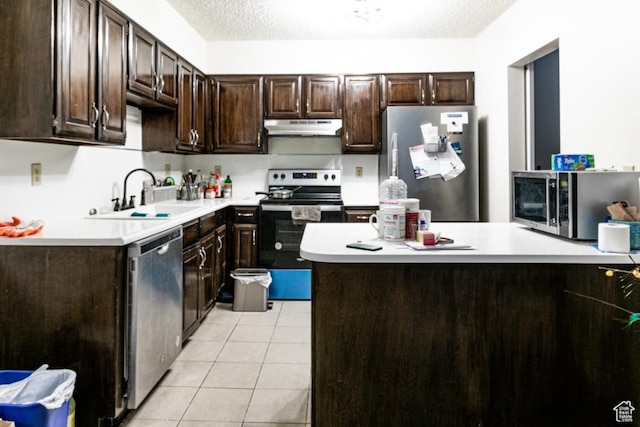 245 N Vine St Unit 205, Salt Lake City, UT 84103 - kitchen with stainless steel appliances, under cabinet range hood, dark brown cabinets, light countertops, and a textured ceiling