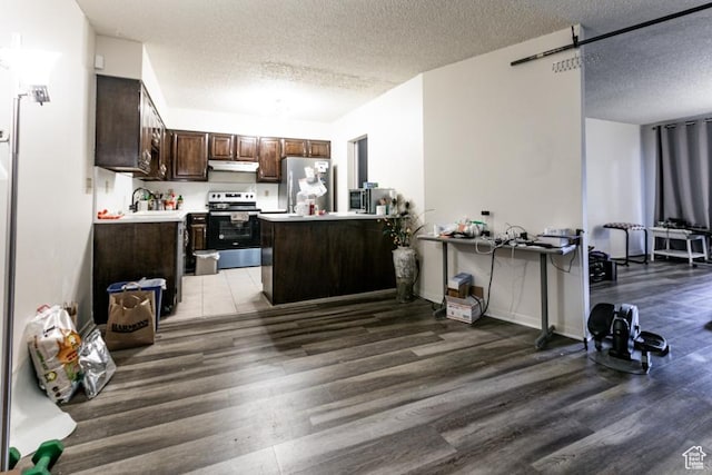 245 N Vine St Unit 205, Salt Lake City, UT 84103 - kitchen featuring appliances with stainless steel finishes, light wood-style flooring, a textured ceiling, under cabinet range hood, and dark brown cabinetry