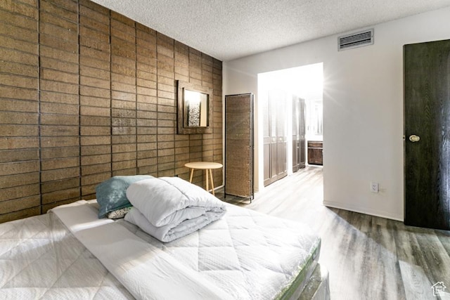 245 N Vine St Unit 205, Salt Lake City, UT 84103 - bedroom featuring a textured ceiling and wood finished floors