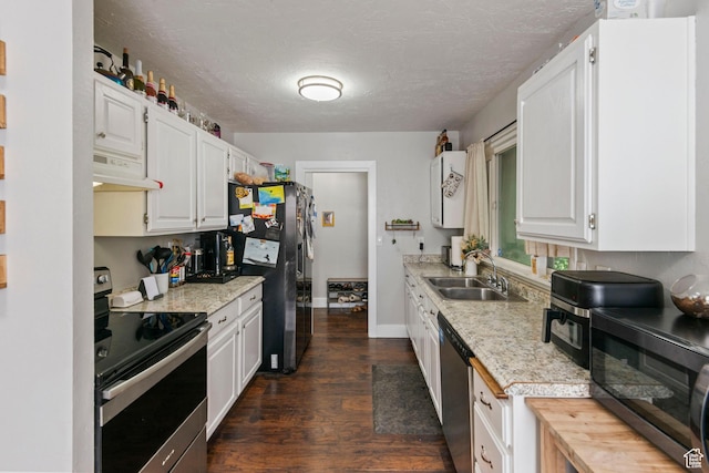 565 W 300 S, Provo, UT 84601 - kitchen with appliances with stainless steel finishes, under cabinet range hood, light countertops, dark wood-style floors, and a textured ceiling