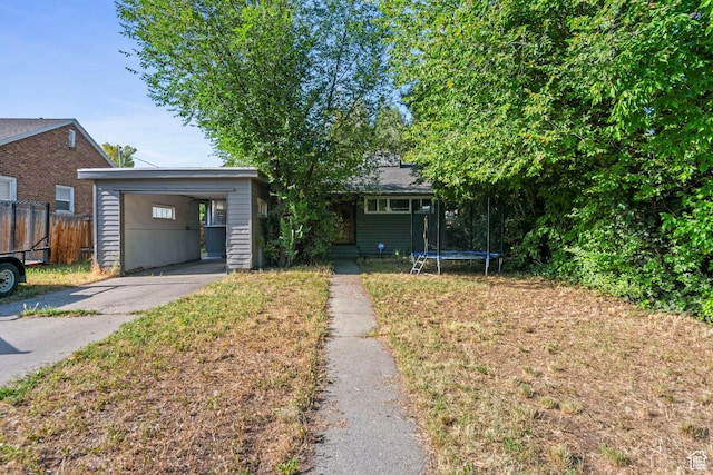 565 W 300 S, Provo, UT 84601 - view of front of home with a trampoline, concrete driveway, and a garage