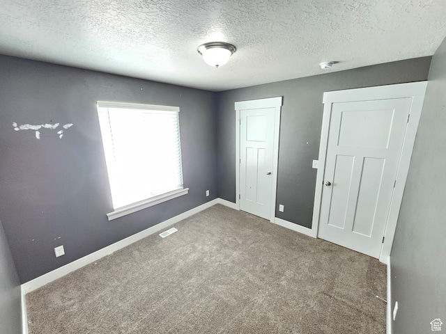 3538 N Willy Way Unit 167, Eagle Mountain, UT 84005 - unfurnished bedroom with a textured ceiling, carpet flooring, and a closet
