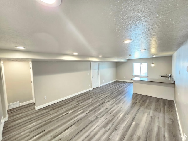 3538 N Willy Way Unit 167, Eagle Mountain, UT 84005 - below grade area featuring wood finished floors, a textured ceiling, and recessed lighting