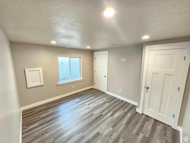 3538 N Willy Way Unit 167, Eagle Mountain, UT 84005 - unfurnished bedroom with a textured ceiling, wood finished floors, and recessed lighting