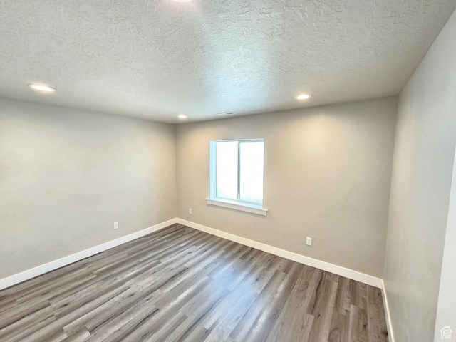 3538 N Willy Way Unit 167, Eagle Mountain, UT 84005 - empty room with dark wood finished floors, a textured ceiling, and recessed lighting