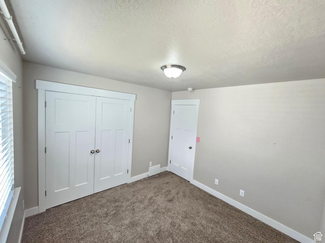 3538 N Willy Way Unit 167, Eagle Mountain, UT 84005 - unfurnished bedroom featuring a textured ceiling, carpet, and a closet