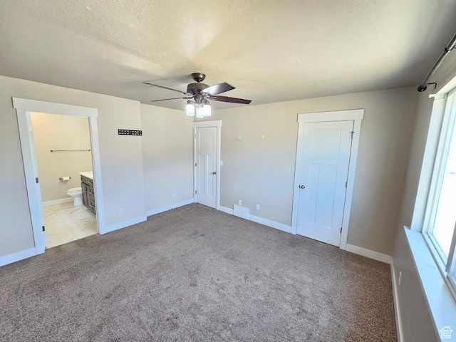 3538 N Willy Way Unit 167, Eagle Mountain, UT 84005 - unfurnished bedroom featuring light colored carpet, ceiling fan, connected bathroom, and a textured ceiling