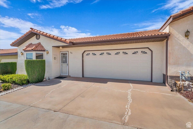 1331 N Dixie Downs Rd Unit 56, St George, UT 84770 - mediterranean / spanish-style house featuring driveway, a garage, stucco siding, and a tiled roof