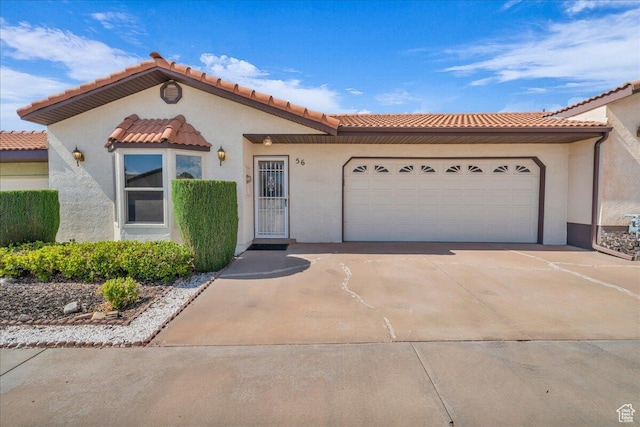 1331 N Dixie Downs Rd Unit 56, St George, UT 84770 - mediterranean / spanish-style house featuring concrete driveway, a garage, stucco siding, and a tile roof