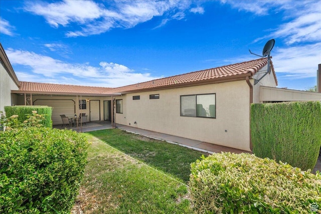 1331 N Dixie Downs Rd Unit 56, St George, UT 84770 - back of property with a tile roof, stucco siding, a patio area, and a lawn