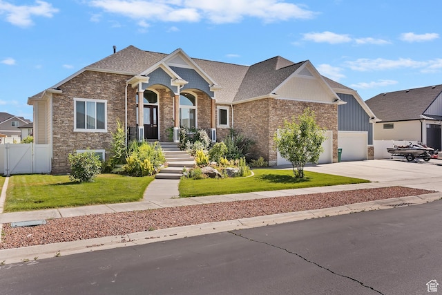 4925 W 3500 S, West Haven, UT 84401 - craftsman-style house featuring concrete driveway, a gate, an attached garage, a shingled roof, and brick siding