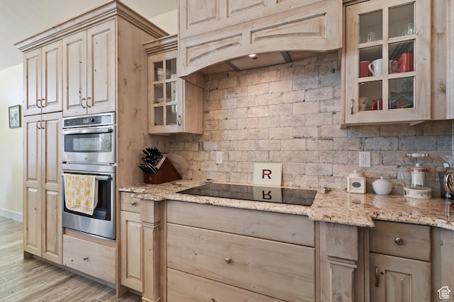 4925 W 3500 S, West Haven, UT 84401 - kitchen featuring black electric stovetop, stainless steel double oven, light wood finished floors, glass insert cabinets, and light stone countertops