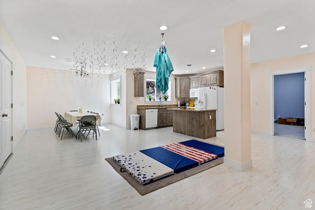 4925 W 3500 S, West Haven, UT 84401 - kitchen with white appliances, a center island, recessed lighting, and light wood finished floors