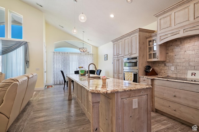 4925 W 3500 S, West Haven, UT 84401 - kitchen featuring light brown cabinetry, stainless steel double oven, a chandelier, vaulted ceiling, and a center island with sink
