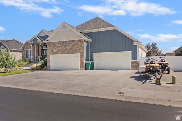 4925 W 3500 S, West Haven, UT 84401 - view of front of home featuring a garage, driveway, board and batten siding, and stone siding