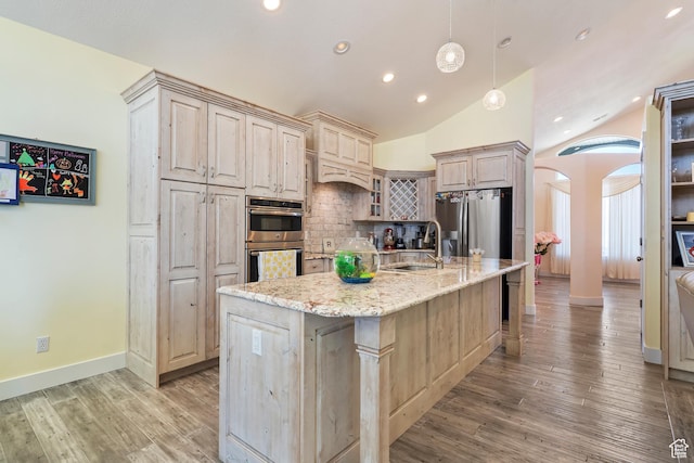 4925 W 3500 S, West Haven, UT 84401 - kitchen with stainless steel appliances, arched walkways, backsplash, recessed lighting, and lofted ceiling