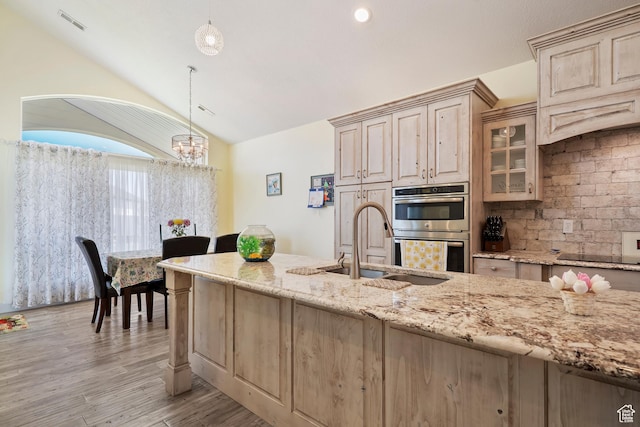 4925 W 3500 S, West Haven, UT 84401 - kitchen featuring double oven, vaulted ceiling, light stone countertops, black electric cooktop, and a chandelier