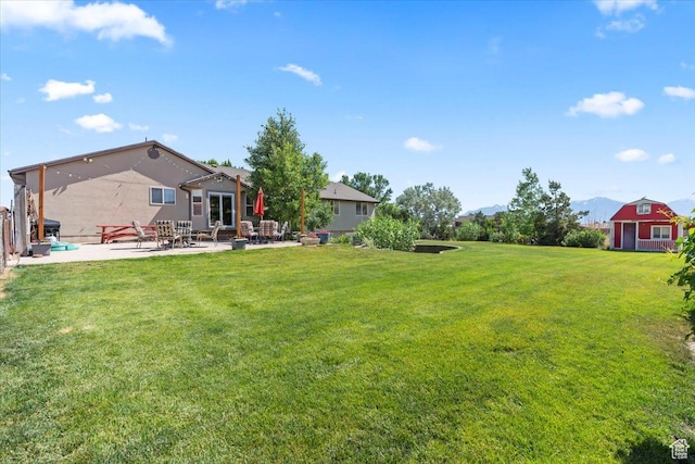 7217 W Mccuiston Ave S, Herriman, UT 84096 - view of green lawn with a patio and a mountain view
