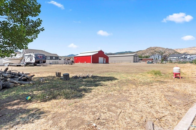 7217 W Mccuiston Ave S, Herriman, UT 84096 - view of yard featuring a mountain view, a pole building, and an outdoor structure