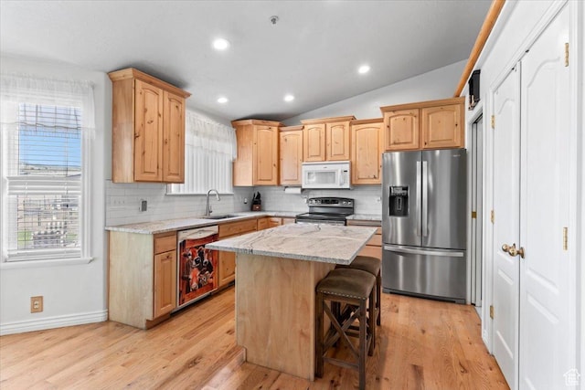 7217 W Mccuiston Ave S, Herriman, UT 84096 - kitchen with stainless steel appliances, tasteful backsplash, light wood-style flooring, light brown cabinets, and lofted ceiling