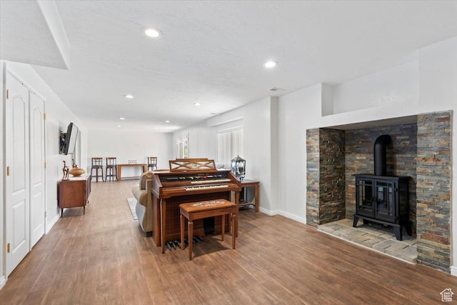 7217 W Mccuiston Ave S, Herriman, UT 84096 - living area featuring wood finished floors, recessed lighting, and a wood stove