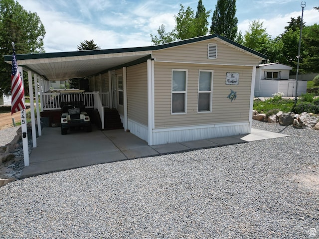 3077 S Edgemont Dr, Garden City, UT 84028 - view of front facade featuring driveway and an attached carport