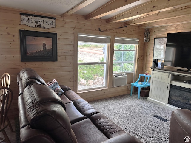 3077 S Edgemont Dr, Garden City, UT 84028 - living room with wood walls, carpet, beamed ceiling, and cooling unit