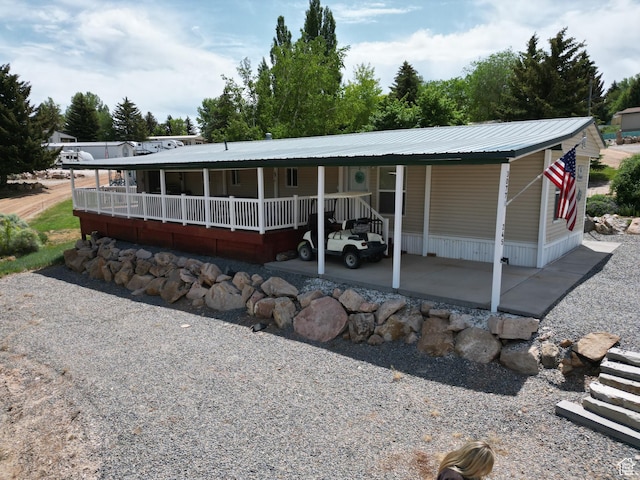 3077 S Edgemont Dr, Garden City, UT 84028 - view of front of house with a metal roof and a carport