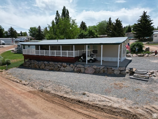 3077 S Edgemont Dr, Garden City, UT 84028 - view of front of home with a metal roof and a porch