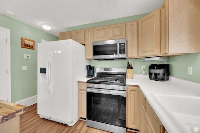 5318 S 4300 W, Hooper, UT 84315 - kitchen with appliances with stainless steel finishes, light brown cabinets, light countertops, and light wood-type flooring