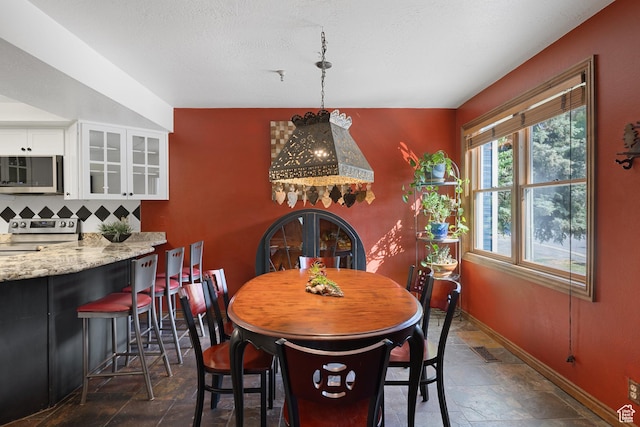 1035 Park Ave Unit 7-G, Park City, UT 84060 - dining space featuring dark stone finish flooring and baseboards
