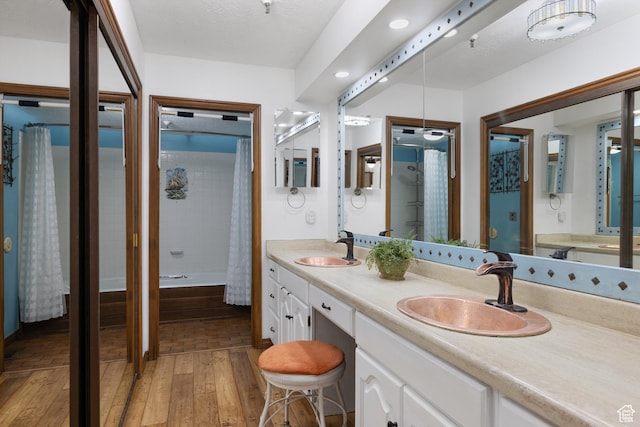 1035 Park Ave Unit 7-G, Park City, UT 84060 - bathroom featuring wood-type flooring, double vanity, shower / tub combo with curtain, and recessed lighting