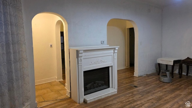 358 E 11th St, Ogden, UT 84404 - living area featuring wood finished floors, arched walkways, and a fireplace