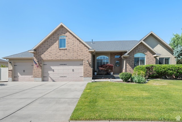 3535 W Overlook Dr, Layton, UT 84041 - view of front of home featuring a front lawn, brick siding, driveway, and a garage