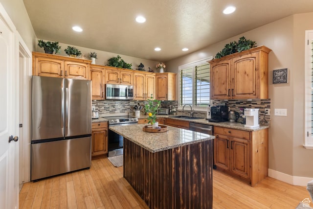 3535 W Overlook Dr, Layton, UT 84041 - kitchen featuring stainless steel appliances, light wood-type flooring, light stone counters, decorative backsplash, and recessed lighting