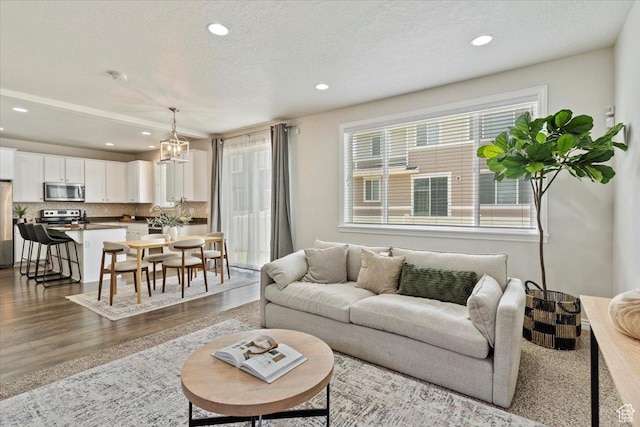 9714 S Oia Ln W, South Jordan, UT 84095 - living room with dark wood-type flooring, recessed lighting, a chandelier, and a textured ceiling