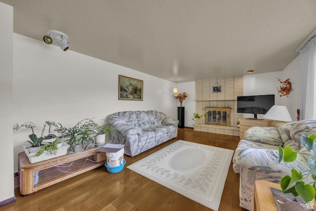 1731 E 1460 N, Logan, UT 84341 - living room featuring wood finished floors and a brick fireplace