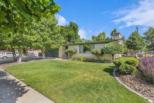 1731 E 1460 N, Logan, UT 84341 - view of front of property featuring brick siding, a chimney, and driveway